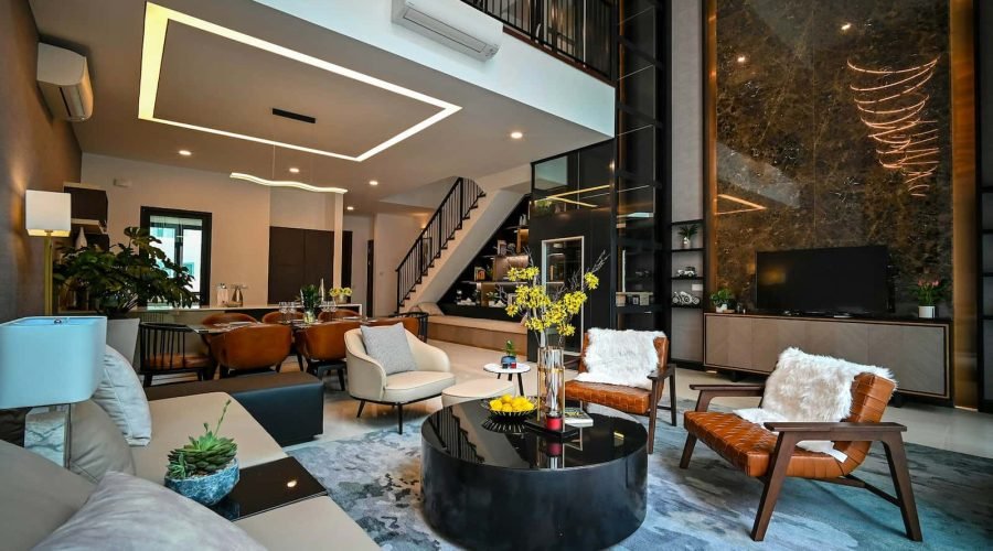 Salon moderne à aire ouverte avec mobilier contemporain, table basse en verre, plantes décoratives et escalier menant à l'étage supérieur. Tons neutres, éclairage d'appoint et grandes fenêtres.